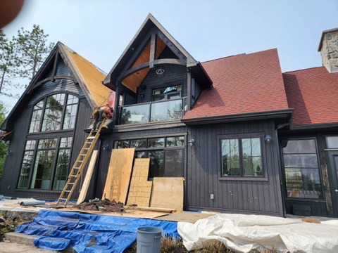Crew working on red shingle cottage roof installation by 905 Roofing Inc. in Durham Region and the GTA