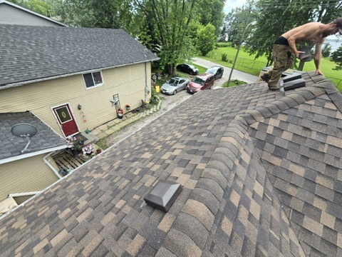 Crew working safely on a completed shingle roof by 905 Roofing Inc. in Durham Region and the GTA