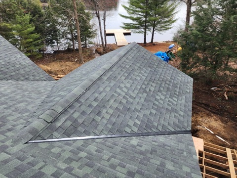 Finished green-grey shingles on lakefront cottage roof by 905 Roofing Inc. in Durham Region and the GTA