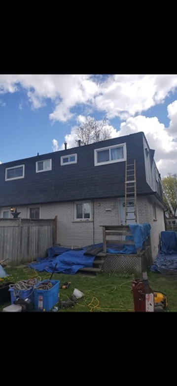 Completed dark roof across rear residential elevation by 905 Roofing Inc. in Durham Region and the GTA