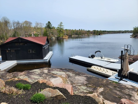 Lakefront boathouse and dock with finished roof by 905 Roofing Inc. in Durham Region and the GTA