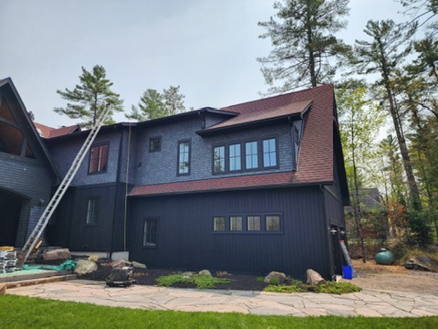 Side elevation of large cottage with red shingle roof by 905 Roofing Inc. in Durham Region and the GTA