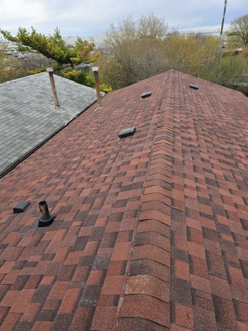 Wide completed red roof with several vents by 905 Roofing Inc. in Durham Region and the GTA