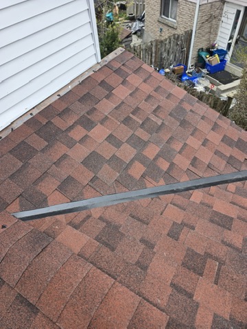 Crew installing underlayment and shingles on red roof project by 905 Roofing Inc. in Durham Region and the GTA
