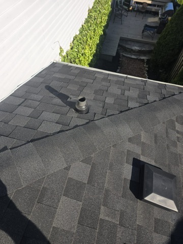 Blue synthetic underlayment and new shingles installed by 905 Roofing Inc. in Durham Region and the GTA