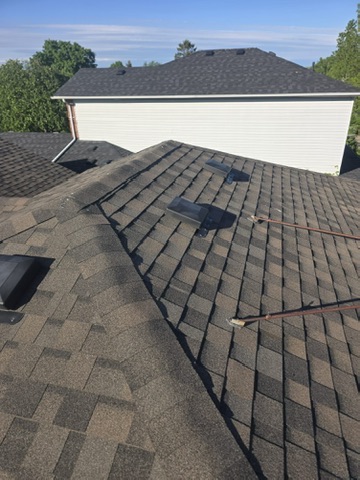 Clean shingle edge and flashing detail beside wall by 905 Roofing Inc. in Durham Region and the GTA