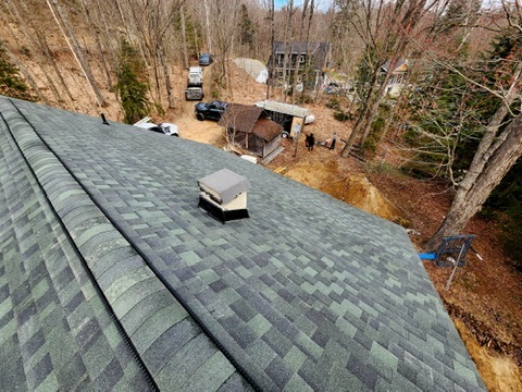 Completed cottage roof surrounded by trees by 905 Roofing Inc. in Durham Region and the GTA
