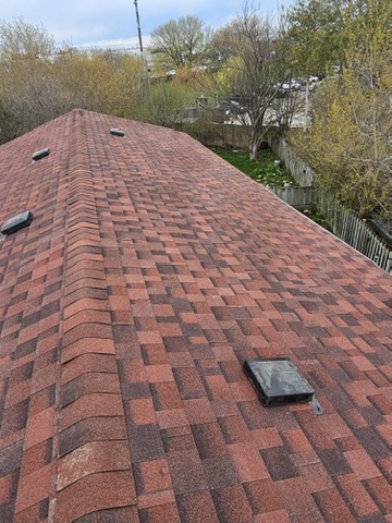 Red shingle roof section with clean flashing detail by 905 Roofing Inc. in Durham Region and the GTA