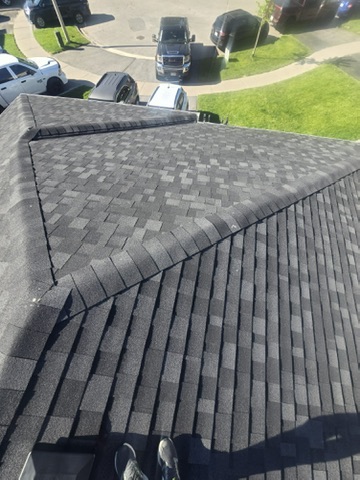Finished shingle roof with chimney flashing detail by 905 Roofing Inc. in Durham Region and the GTA